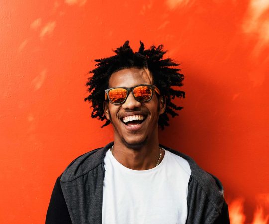 portrait-of-handsome-afro-man-using-his-mobile-EDDNTK6-1.jpg